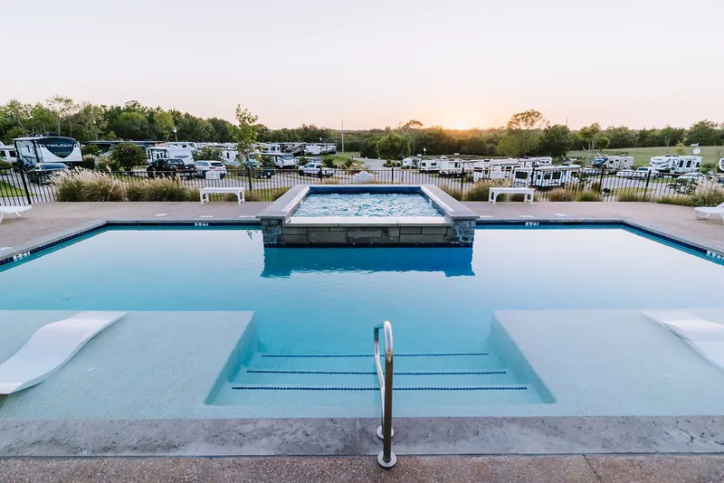 Pool and hot tub area at dusk